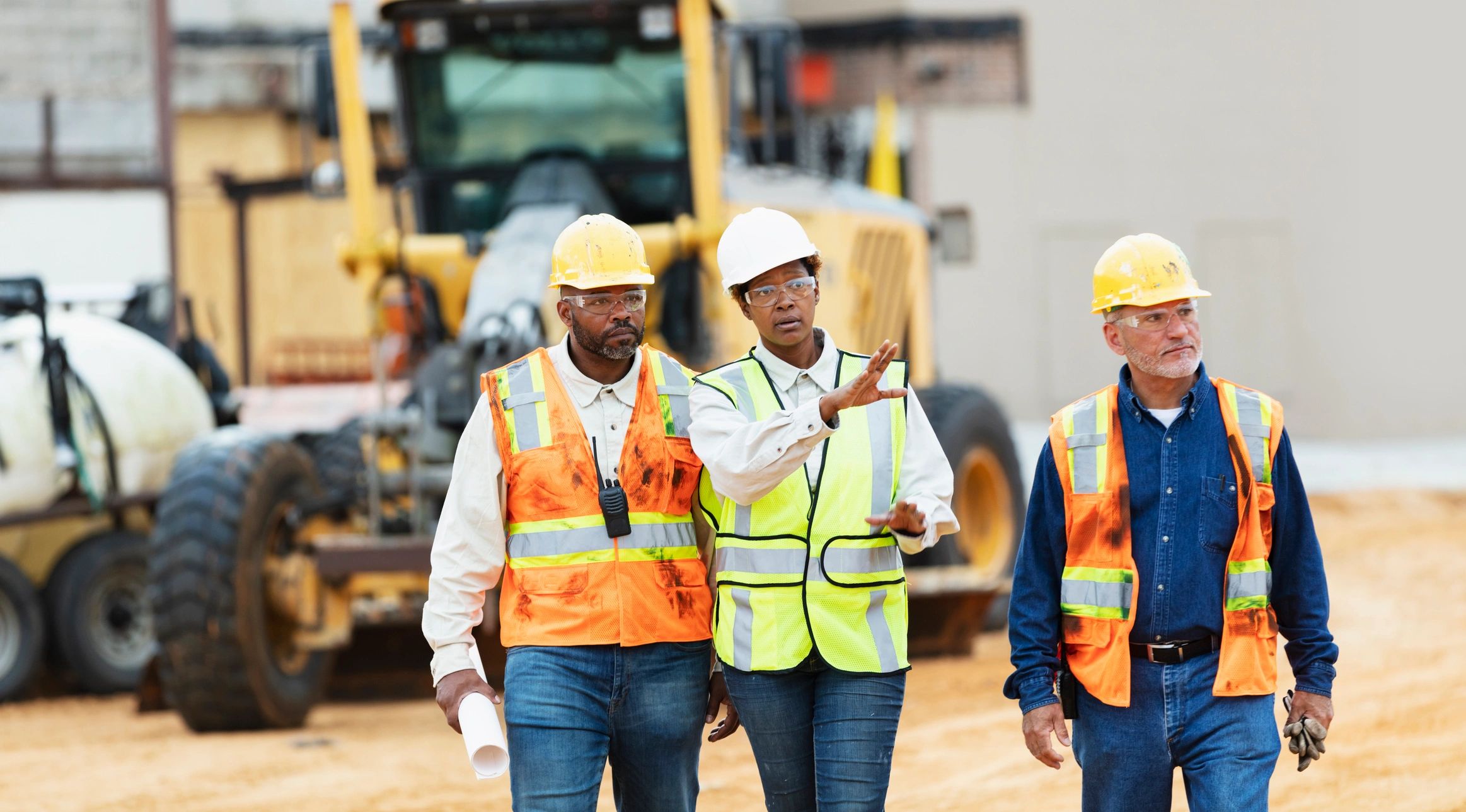 Construction supervisor leading workers through a job site