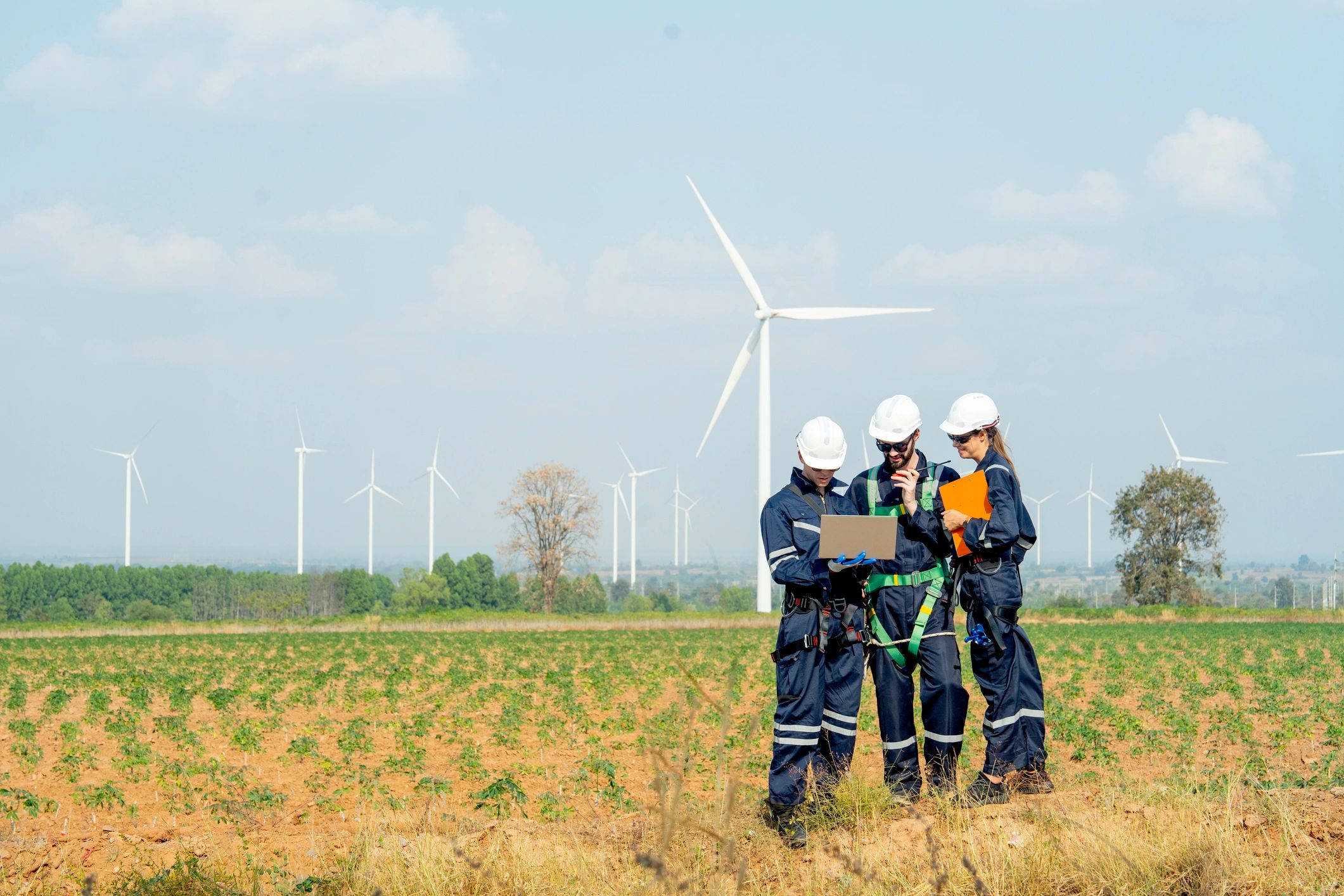 Technical workers collaborating outdoors on an industrial site